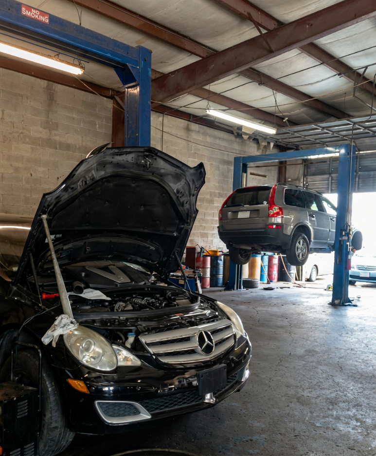 Vehicles being serviced inside Discount Auto Care